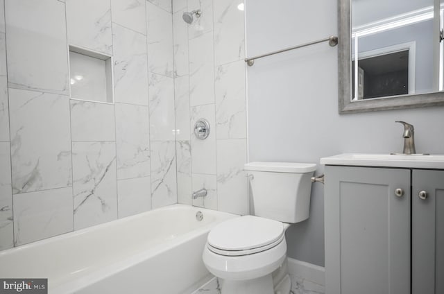 full bathroom with tiled shower / bath, vanity, and toilet