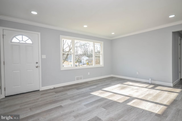 entrance foyer with crown molding and light hardwood / wood-style floors