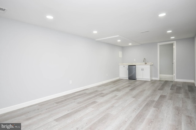 interior space with light hardwood / wood-style floors and indoor wet bar