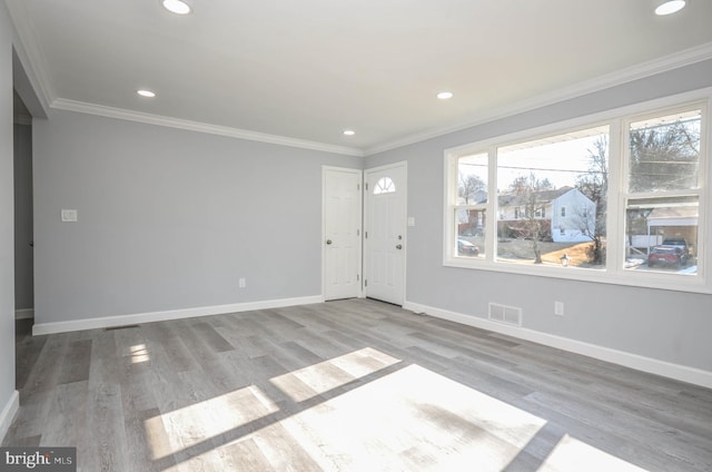 foyer entrance featuring ornamental molding and light hardwood / wood-style floors