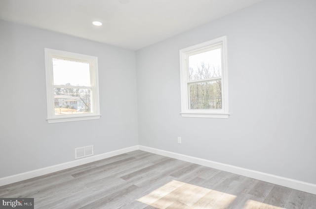 spare room with light hardwood / wood-style flooring