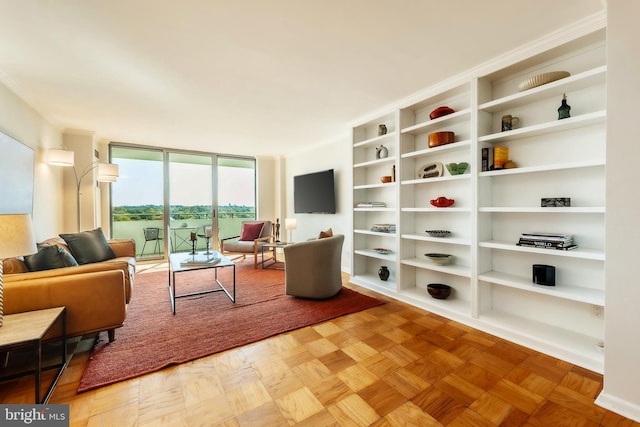 living room with parquet flooring and a wall of windows