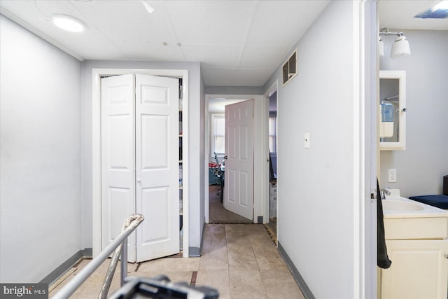 hall featuring a drop ceiling