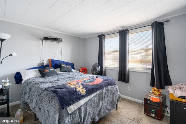 bedroom with crown molding and carpet