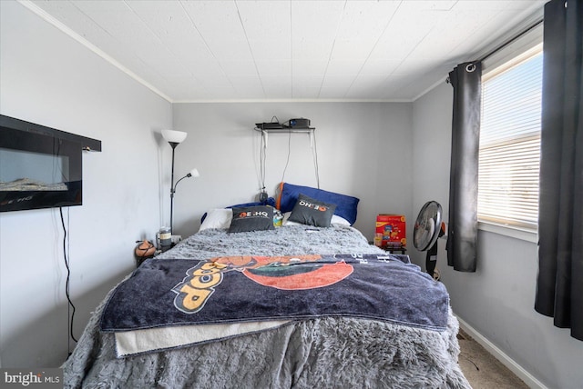 bedroom featuring ornamental molding and carpet flooring