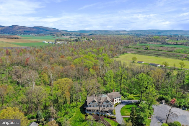 drone / aerial view featuring a mountain view and a rural view