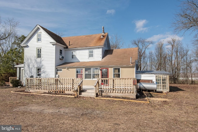 back of house featuring cooling unit, a deck, and a sunroom