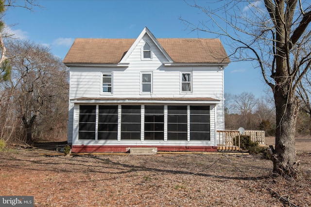 rear view of property with a sunroom