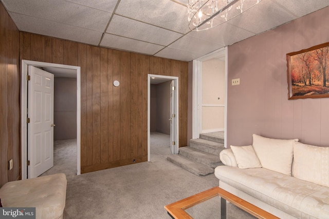 living room featuring carpet floors and wooden walls