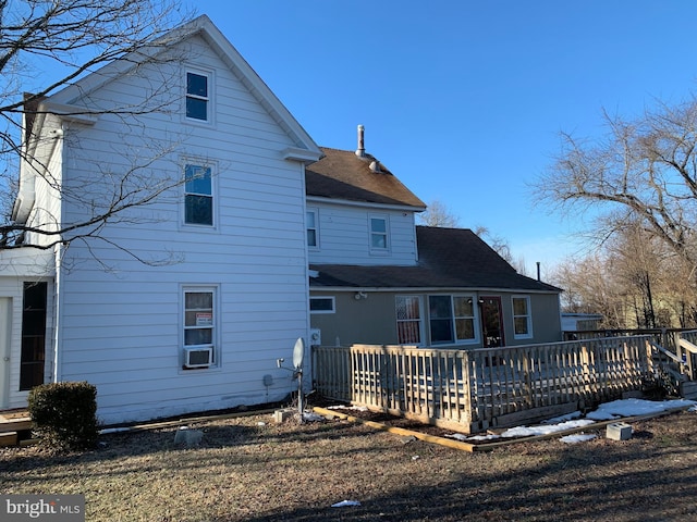 back of house with a wooden deck