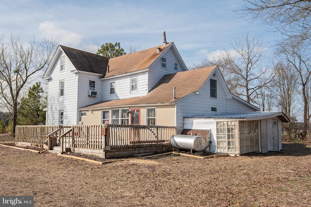 rear view of house with cooling unit and a deck