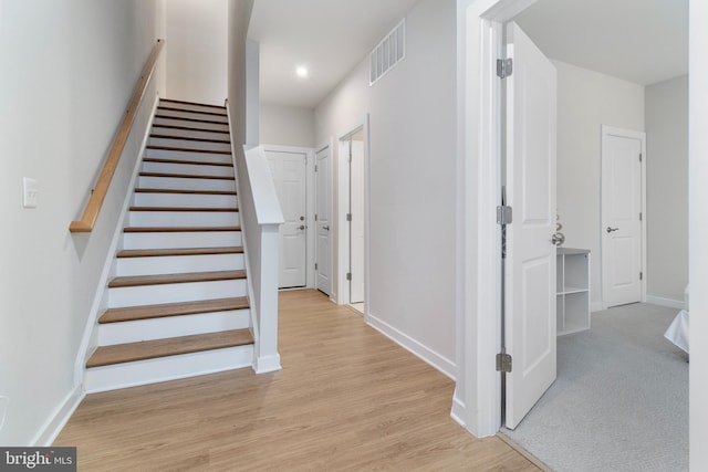 stairs featuring hardwood / wood-style flooring