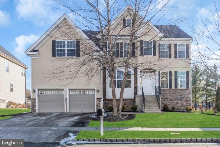 view of front of house with a garage and a front yard