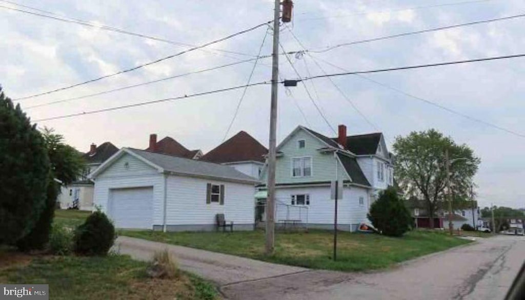 view of front of property with a garage and a front lawn