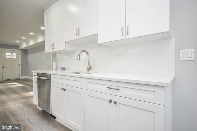 kitchen with light stone countertops, white cabinets, light wood-type flooring, and decorative backsplash