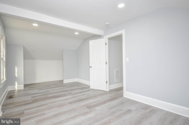 additional living space with lofted ceiling and light hardwood / wood-style floors