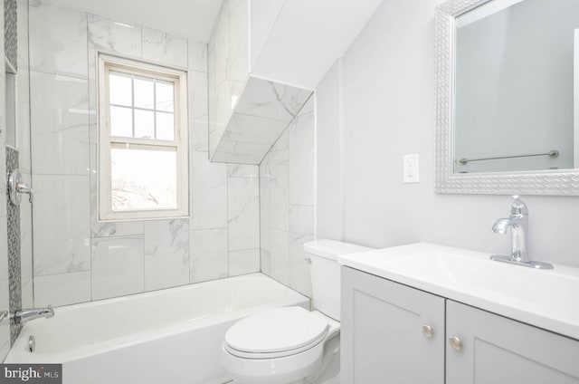 full bathroom with tiled shower / bath, vanity, and toilet