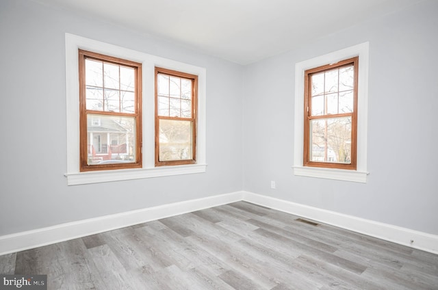 unfurnished room with light hardwood / wood-style floors