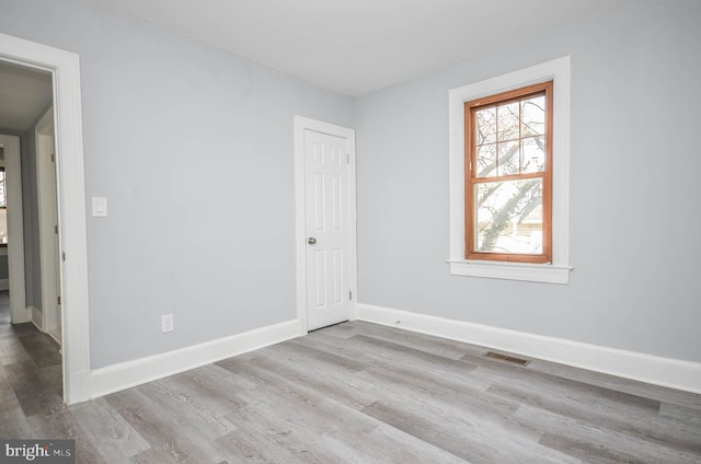 unfurnished room with light hardwood / wood-style floors