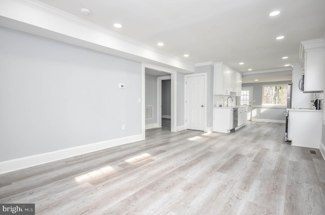 unfurnished living room with crown molding and light hardwood / wood-style flooring