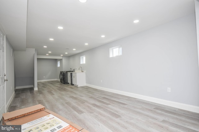 basement with light hardwood / wood-style floors