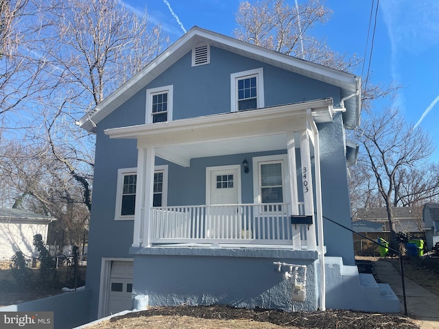 view of front of home with a garage and a porch