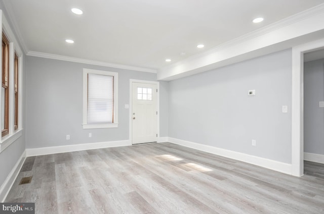 entrance foyer featuring crown molding and light wood-type flooring