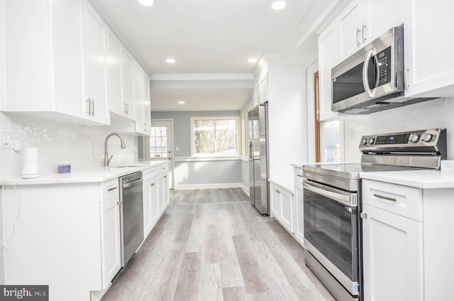 kitchen with appliances with stainless steel finishes and white cabinets