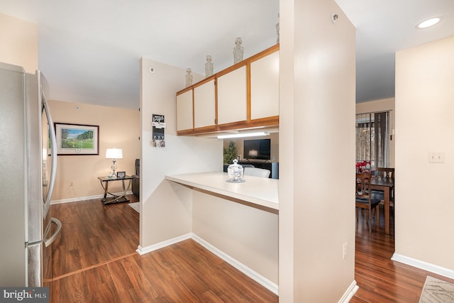 kitchen with white cabinetry, stainless steel fridge, and dark hardwood / wood-style floors