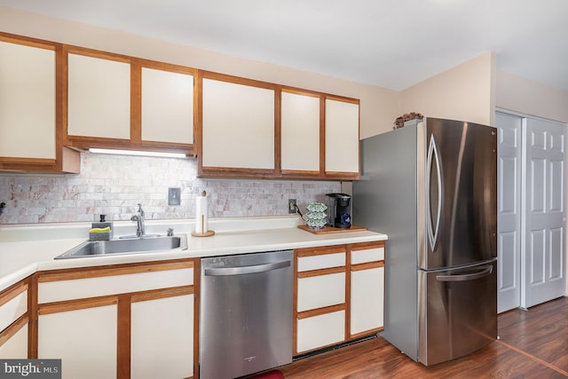 kitchen featuring appliances with stainless steel finishes, sink, decorative backsplash, and white cabinets