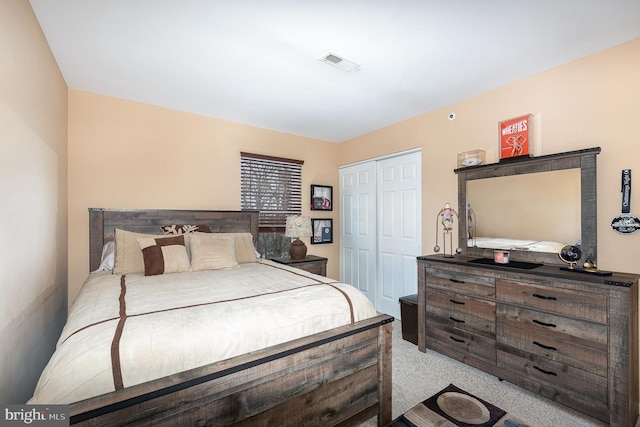 carpeted bedroom with a closet