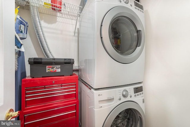 clothes washing area featuring stacked washer / dryer