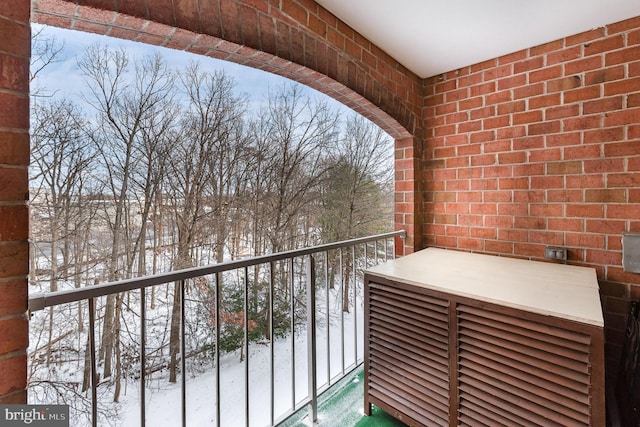 view of snow covered back of property