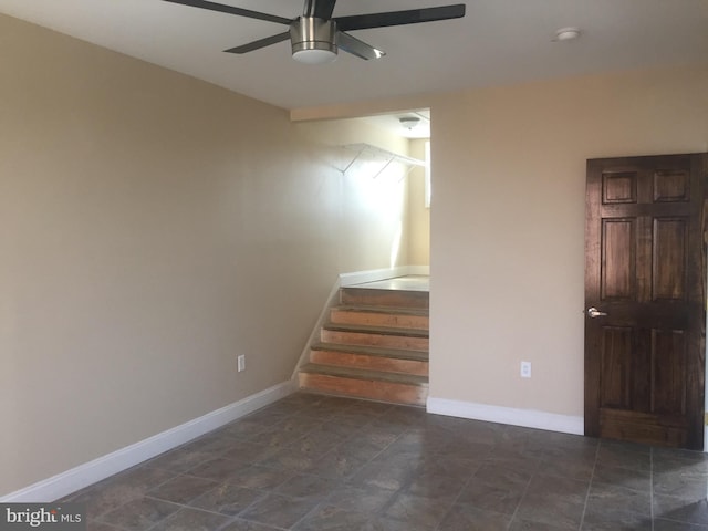 staircase featuring ceiling fan