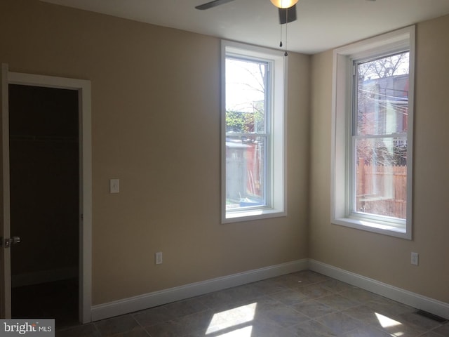 spare room with ceiling fan