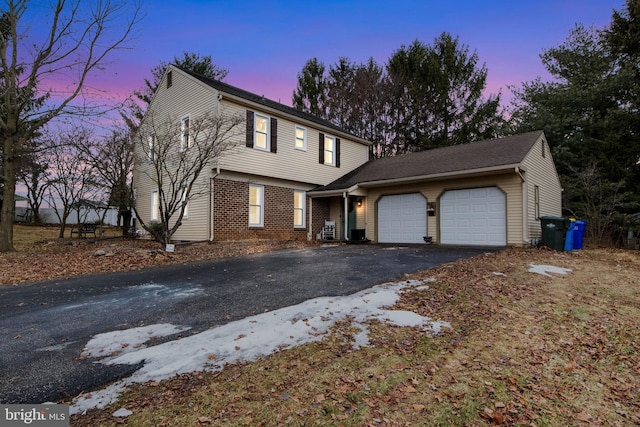 view of property with a garage and central air condition unit