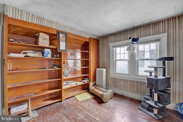 living area featuring wood-type flooring and radiator