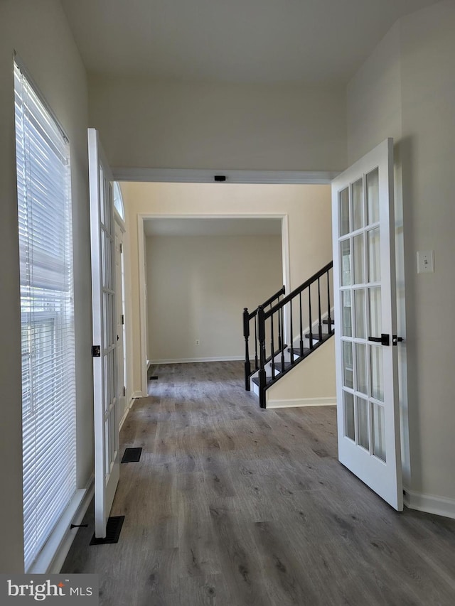 corridor featuring wood-type flooring and french doors