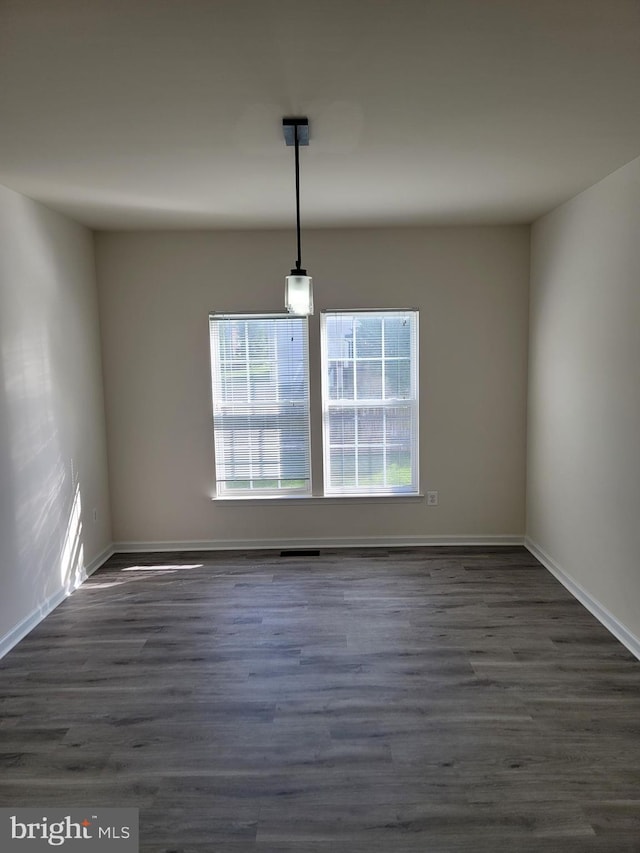 unfurnished dining area with dark hardwood / wood-style flooring