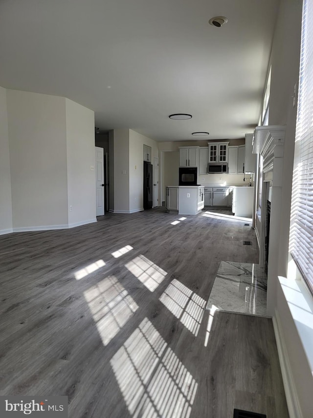 unfurnished living room with a fireplace and dark hardwood / wood-style floors