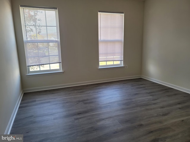 unfurnished room featuring dark wood-type flooring