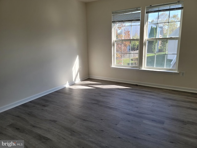 spare room featuring dark hardwood / wood-style flooring