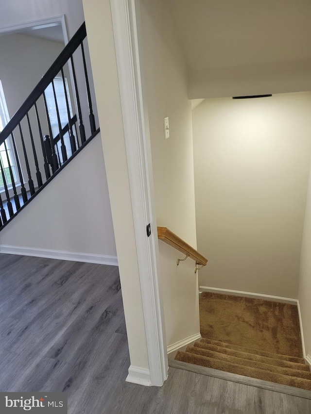 stairway with hardwood / wood-style flooring