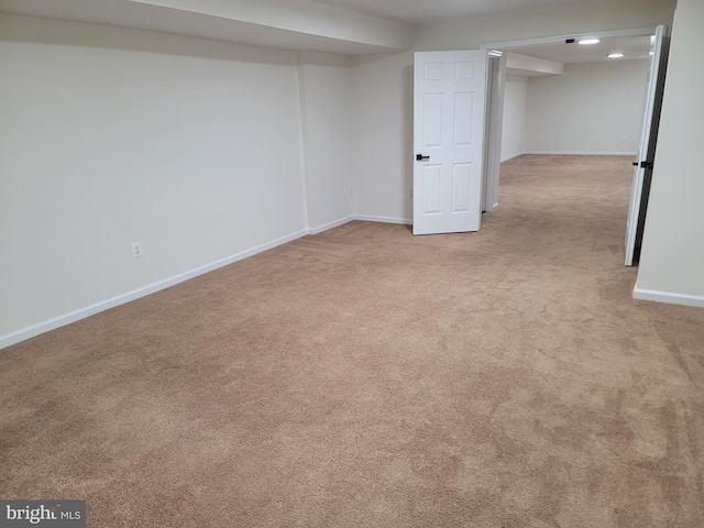 basement featuring fridge and light carpet