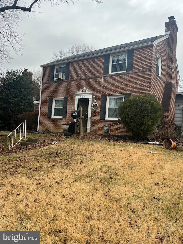 view of front of home featuring cooling unit and a front lawn