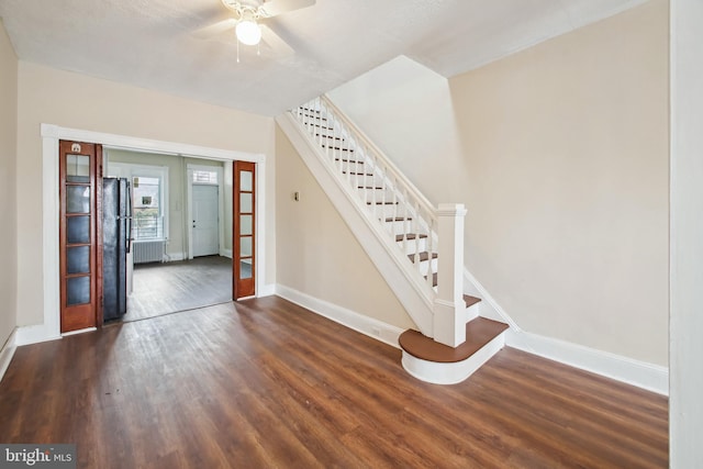 interior space featuring radiator heating unit, wood-type flooring, french doors, and ceiling fan