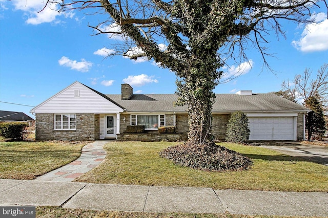 ranch-style house featuring a garage and a front lawn