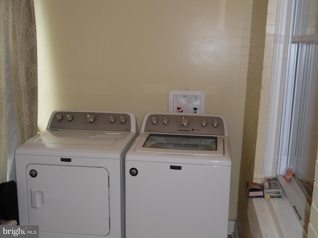 clothes washing area with washer and dryer