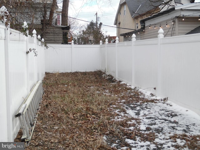 view of yard layered in snow