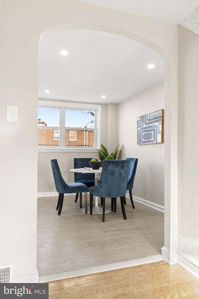 dining space featuring wood-type flooring